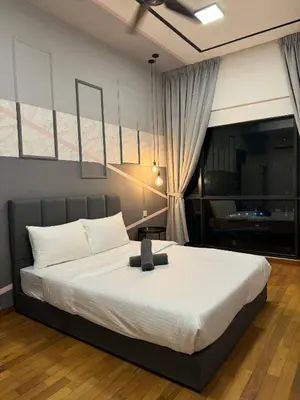 a bedroom with a large bed with white sheets at REIZZ RESIDENCE BY BERJAYA in Kuala Lumpur