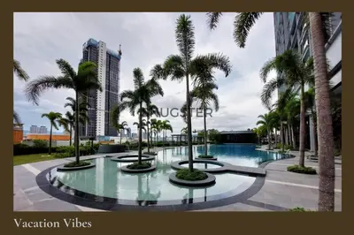 a resort with palm trees and a swimming pool at Stunning Pool & the City - 1 mrt stop to TRX in Kuala Lumpur