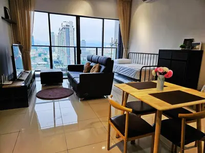 a living room with a couch and a table at Stunning Pool & the City - 1 mrt stop to TRX in Kuala Lumpur