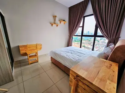 a bedroom with a bed and a table and a window at Stunning Pool & the City - 1 mrt stop to TRX in Kuala Lumpur