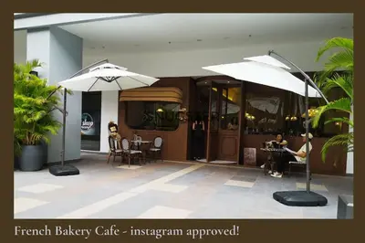 two white umbrellas in front of a building at Stunning Pool & the City Studio- 1 Mrt stop to TRX in Kuala Lumpur