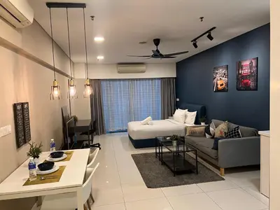 a living room with a bed and a couch at Summer Suites KLCC By Victorians in Kuala Lumpur