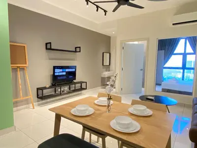 a living room with a table and a tv at VALENTINA SUITES @ ARTE MONT KIARA in Kuala Lumpur