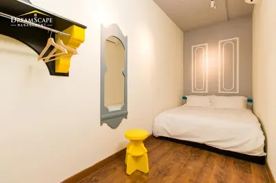 a small bedroom with a bed and a mirror at VALENTINA SUITES @ ARTE MONT KIARA in Kuala Lumpur