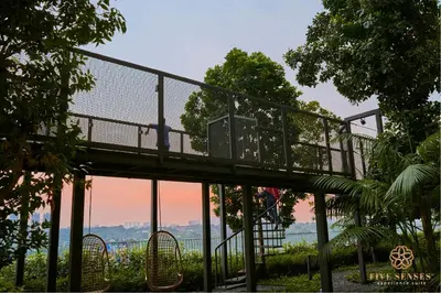 a walkway with a bridge in a park at Trion One Suites Kuala Lumpur by Five Senses in Kuala Lumpur