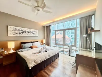a bedroom with a bed and a desk and a window at Lot163 By ZenGlo in Kuala Lumpur
