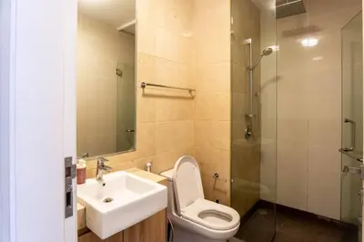 a bathroom with a toilet and a sink and a shower at M City Residence by Airhost in Kuala Lumpur