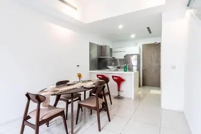 a kitchen and dining room with a table and chairs at M City Residence by Airhost in Kuala Lumpur