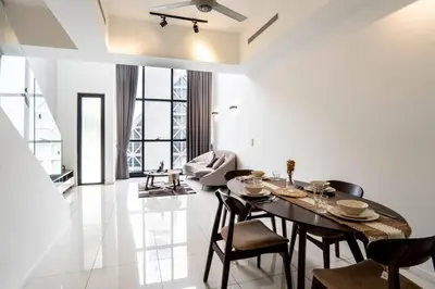 a living room with a dining room table and chairs at M City Residence by Airhost in Kuala Lumpur