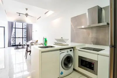 a kitchen with a washing machine and a sink at M City Residence by Airhost in Kuala Lumpur