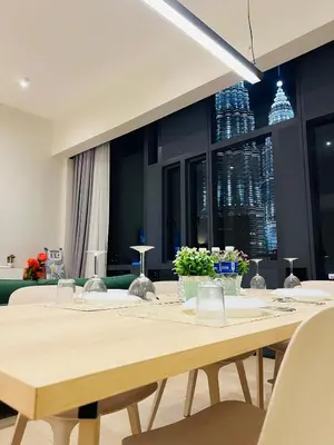 a dining room with a table and a couch at Star at KLCC By EAE in Kuala Lumpur
