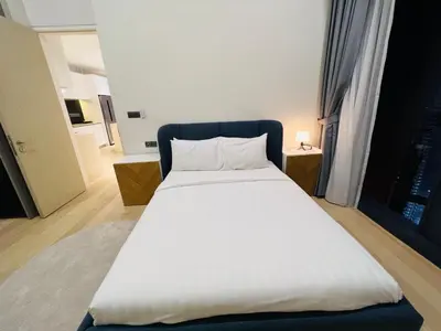 a bedroom with a large white bed and a window at Star at KLCC By EAE in Kuala Lumpur