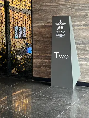 a sign in front of a wall with a bottle of wine at Star at KLCC By EAE in Kuala Lumpur