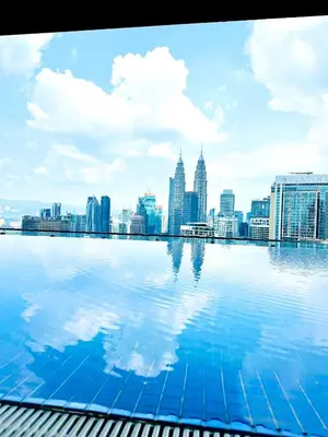 a view of a city skyline from a swimming pool at Voyage Bedroom, The Luxe Colony in Kuala Lumpur