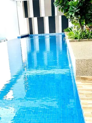 a large blue swimming pool with blue water at Voyage Bedroom, The Luxe Colony in Kuala Lumpur