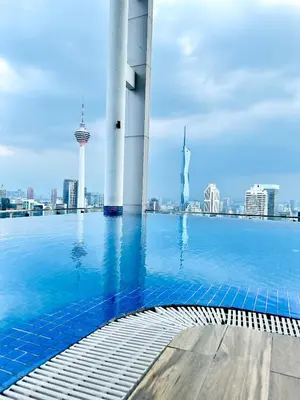 a swimming pool with a view of the city at Voyage Bedroom, The Luxe Colony in Kuala Lumpur