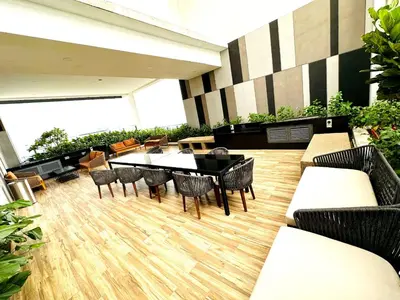 a dining room with a table and chairs in a building at Voyage Bedroom, The Luxe Colony in Kuala Lumpur