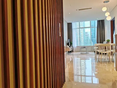 a living room with a wooden partition with a dining room at Sky Suites KLCC 3min walk to Twin Tower in Kuala Lumpur