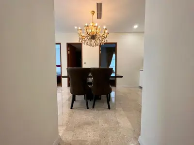 a dining room with a table and a chandelier at Sky Suites KLCC 3min walk to Twin Tower in Kuala Lumpur