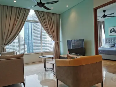 a living room with a bed and a television at Sky Suites KLCC 3min walk to Twin Tower in Kuala Lumpur