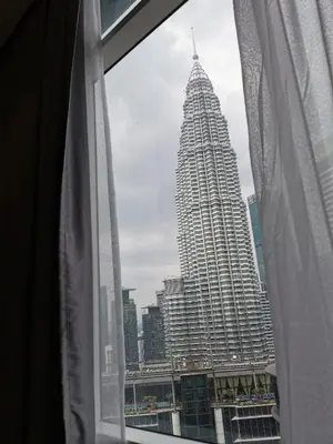 a view of a tall building from a window at Sky Suites KLCC 3min walk to Twin Tower in Kuala Lumpur