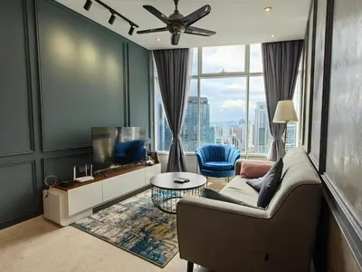 a living room with a couch and a tv at Sky Suites KLCC 3min walk to Twin Tower in Kuala Lumpur