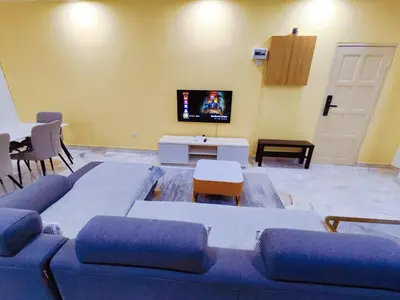 a living room with a blue couch and a tv at Nice Stay 16pax at Wisma Cosway Pavilion KLCC Bukit Bintang in Kuala Lumpur