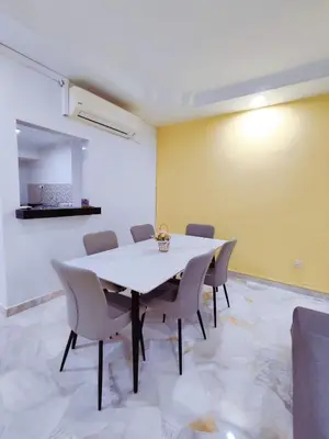a dining room with a white table and chairs at Nice Stay 16pax at Wisma Cosway Pavilion KLCC Bukit Bintang in Kuala Lumpur