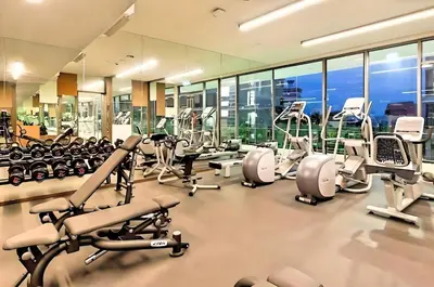 a gym with a lot of treadmills and machines at Robertson Residences in Kuala Lumpur