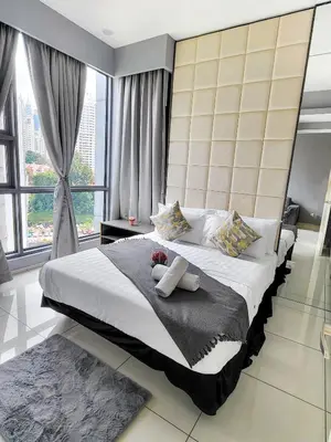 a bedroom with a large bed with a large window at Robertson Residences in Kuala Lumpur