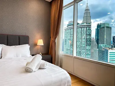 a bedroom with a bed and a large window at Vortex KLCC by apartx in Kuala Lumpur