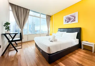 a bedroom with a large bed and a large window at Vortex KLCC by apartx in Kuala Lumpur