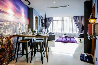 a living room with a table and some chairs at Vortex KLCC by apartx in Kuala Lumpur