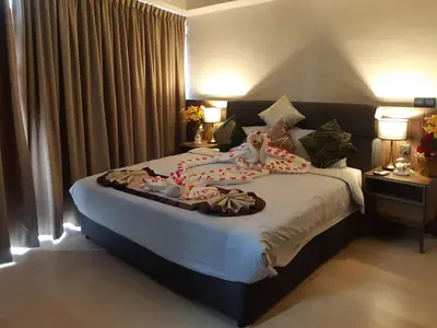 a bedroom with a large bed with clothes on it at KLCC Star Suites by BBA in Kuala Lumpur