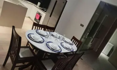 a table with chairs and a blue and white plates on it at KLCC Star Suites by BBA in Kuala Lumpur