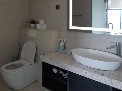 a bathroom with a sink and a toilet and a mirror at KLCC Star Suites by BBA in Kuala Lumpur