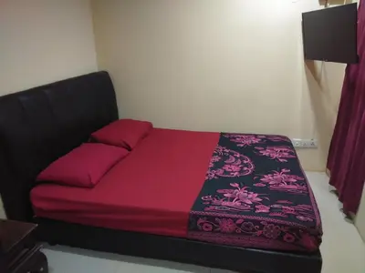 a bed in a room with a purple bedspread at KL CITY LODGE in Kuala Lumpur