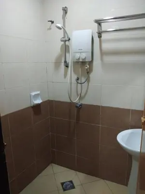 a bathroom with a shower with a toilet and a sink at KL CITY LODGE in Kuala Lumpur