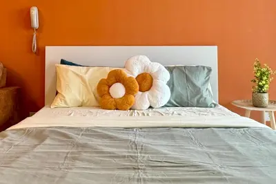 a stuffed teddy bear sitting on top of a bed at Continew by Xuan and Partner near KLCC and Bukit Bintang in Kuala Lumpur