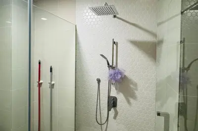 a shower with a umbrella hanging on a wall at Continew by Xuan and Partner near KLCC and Bukit Bintang in Kuala Lumpur