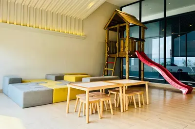a play room with a table and a slide at Continew by Xuan and Partner near KLCC and Bukit Bintang in Kuala Lumpur