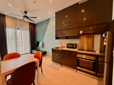 a kitchen with a table and a dining room at Smart Home at Lucentia Residence BBCC Lalaport in Kuala Lumpur