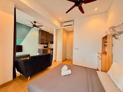 a living room with a bed and a ceiling fan at Smart Home at Lucentia Residence BBCC Lalaport in Kuala Lumpur