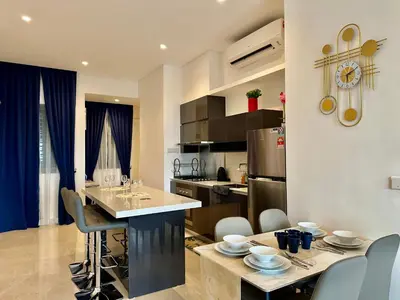 a kitchen and living room with a table and chairs at Smart Home at Lucentia Residence BBCC Lalaport in Kuala Lumpur