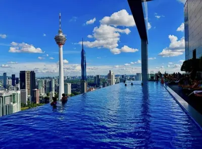 a infinity pool on the top of a building with a city skyline at The Platinum KLCC By Luxe Suites in Kuala Lumpur