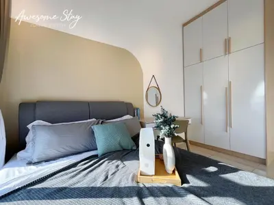 a bedroom with a bed with a vase on a table at Trion @ KL By The Relaxstay in Kuala Lumpur