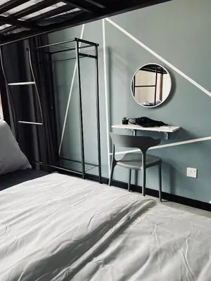 a bedroom with a bed and a mirror and a desk at Neu suites advance HomeStay klcc in Kuala Lumpur