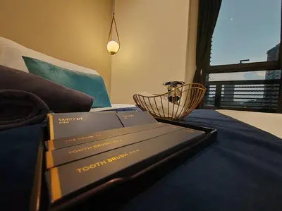two books sitting on top of a bed at Arcoris Mont Kiara 7# Main Street #Walking 1MK# 163 Retails# 2 BR Balcony 2-4Pax in Kuala Lumpur