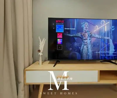 a flat screen tv sitting on top of a wooden table at Arcoris Mont Kiara 19# Deluxe 1 Bedroom With Balcony KL #1-3Pax in Kuala Lumpur