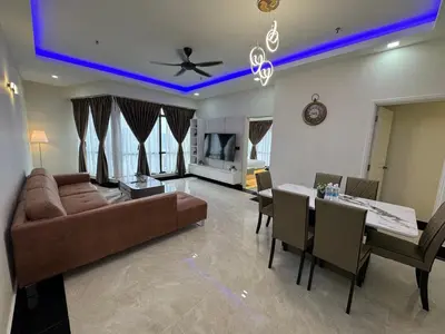 a living room with a couch and a dining room at The Suites at Times Square KL by Robinsons in Kuala Lumpur